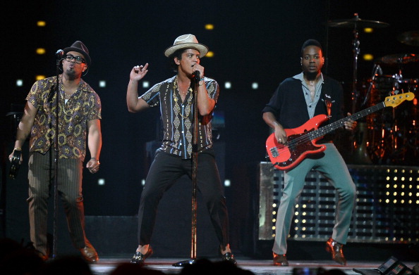 LAS VEGAS, NV - SEPTEMBER 21:  (L-R) Singer/songwriter Philip Lawrence, recording artist Bruno Mars and bassist Jamareo Artis perform during the iHeartRadio Music Festival at the MGM Grand Garden Arena on September 21, 2013 in Las Vegas, Nevada.  (Photo by Ethan Miller/Getty Images for Clear Channel)